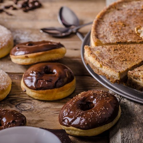 Old style donuts with sugar and dark chocolate, whole table, place for your advertising